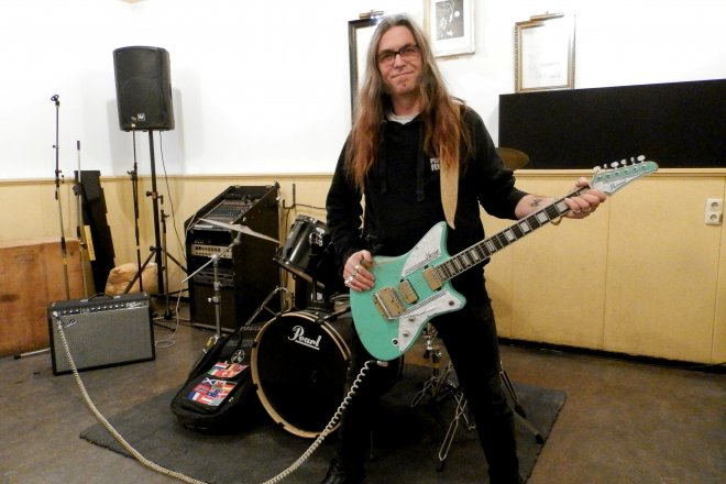 Eris Geevers in SPOD poseert met een elektrische gitaar